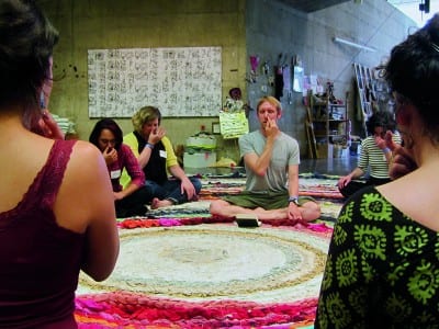 Christian Nagler, Yoga for Adjuncts, 2014, at the Valuing Labor in the Arts Practicum, UC Berkeley Art Museum, April 19, 2014 (photographs © Megan Hoetger, provided by the artist).  Rug: Fritz Haeg, Domestic Integrity Field, 2012–14, crocheted and spirally stitched rug created from local textiles by volunteers, on view January 29–June 1, 2014 (artwork © Fritz Haeg). 