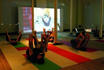 Christian Nagler, Market Fitness class with participants in happy baby pose, 2012, yoga class taught by the author, Headlands Center for the Arts, Marin, California, March 11, 2012 (photograph © Azin Seraj, provided by the artist)