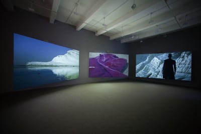 Isaac Julien, Western Union: Small Boats, 2007, three-screen projection, 35mm color film, DVD/HD transfer, 5.1 SR sound, 18 min. 22 sec., edition of 5, installation views, Metro Pictures, New York, 2007 (artwork © Isaac Julien; photographs provided by Metro Pictures, New York)
