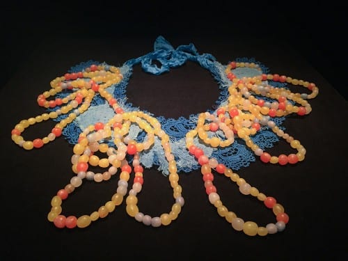 Anna Dumitriu, Engineered Antibody, 2015–2016, twenty-one amino acids, polymer clay, Coomassie Brilliant Blue dye, jewellery wire, cotton calico, vintage tatted linen lace, silk, and embroidery, based on research by Xiang Li (Liu Lab, University of California, Irvine) (artwork © Anna Dumitriu; photograph provided by Beall Center for Art + Technology, University of California, Irvine)