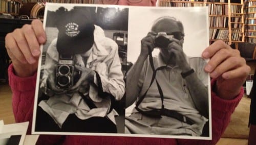 Hank O’Neal holds a photograph depicting himself and Berenice Abbott taking photographs of one another, 2015 (photograph © Hank O'Neal; photograph © Anna Craycroft)