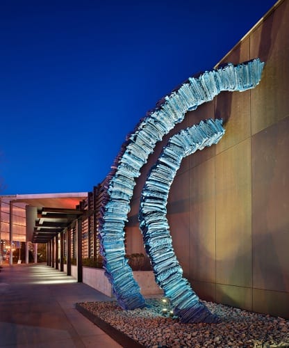 Marie Watt, Blanket Stories: Transportation Object, Generous Ones, Trek, 2014, cast bronze, 18 x 4 x 6 ft. (5.49 x 1.22 x 1.83 m).  Permanent installation, Tacoma Art Museum, Tacoma, Washington (artwork © Marie Watt; photograph by Benjamin Benschneider/OTTO) “Transportation object” is the term used to classify cradleboards at the Smithsonian National Museum of the American Indian. “Generous ones” acknowledges Tacoma’s indigenous inhabitants, the Puyallup and Coast Salish People. The name Puyallup or S’Puyalupubsh means “generous and welcoming behavior to all people (friends and strangers) who enter our lands.” “Trek” reflects on slow journeys, as well as the dynamic confluence and exchange that is a part of migrating and settling. To read the stories associated with the donated blankets, see http://blanketstories.tacomaartmuseum.org, as of June 5, 2017.