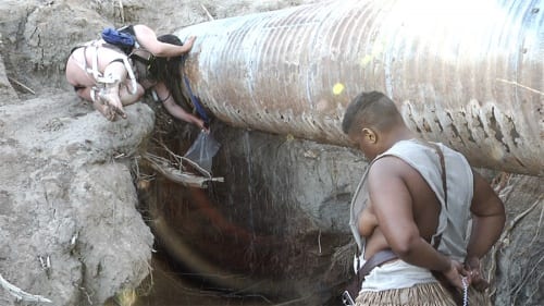 Free Radicals, performed by niv Acosta and Jen Rosenblit, gather water from a leaking pipe. A.K. Burns, video still from A Smeary Spot, 2015, four-channel video installation, HD color, six-channel sound, TRT 53:13 (artwork © A.K. Burns, image provided by the artist, Callicoon Fine Arts, NY, and Michel Rein Gallery, Paris/Brussels)