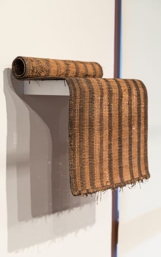 Unidentified Artist, Tuareg (Mali, Niger), smaller prayer mat shown rolled on shelf, ca.1970s, reed and leather, installation view, Made to Move: African Nomadic Design, Handwerker Gallery, 2017. Collection of Herbert F. Johnson Museum of Art (photograph by Risham Majeed) 