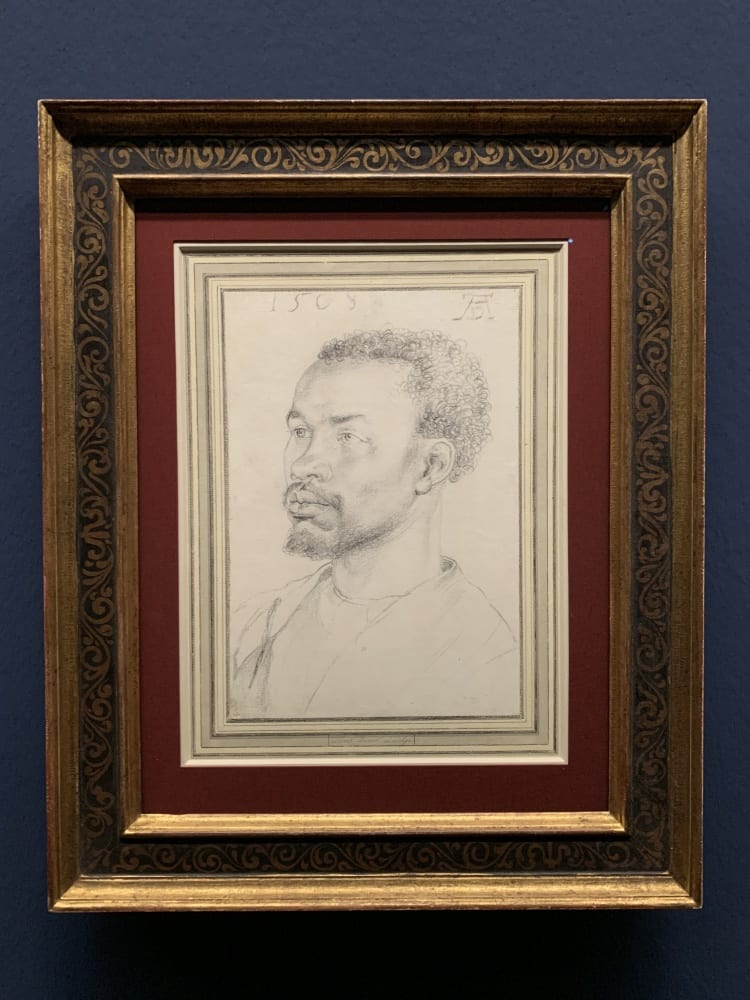 chalk drawing of a black man with a goatee in three quarters view