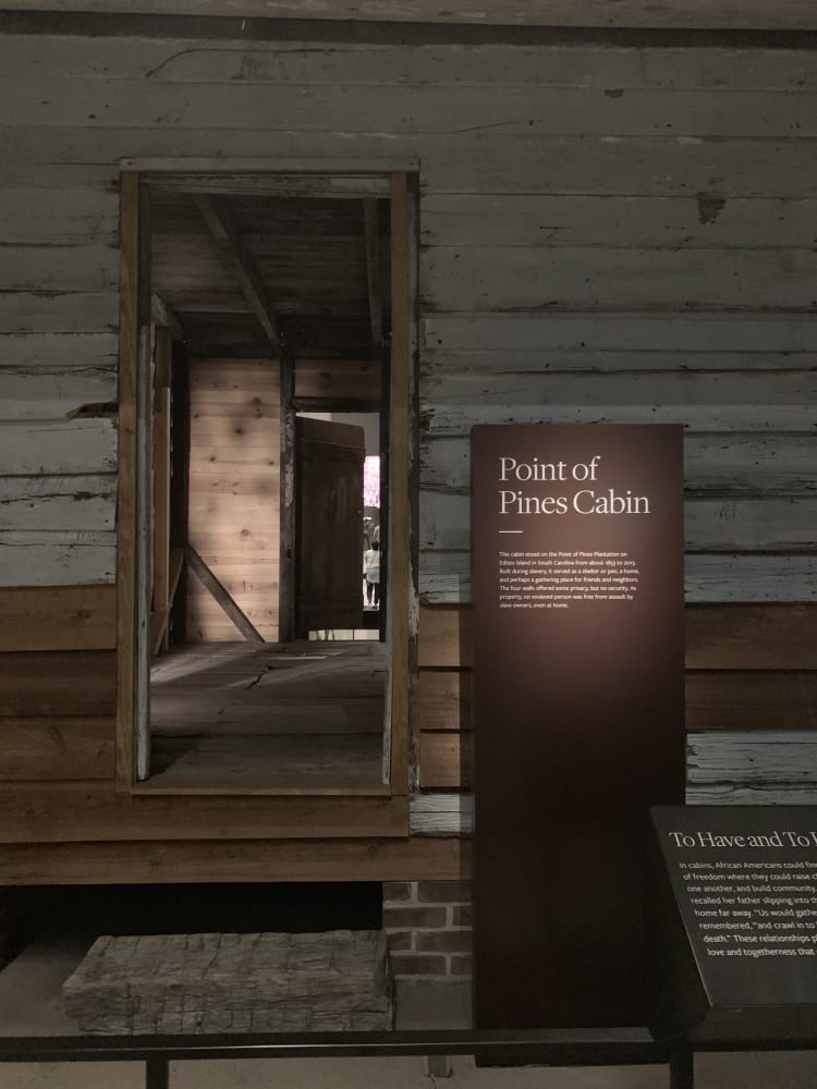 Looking into a small wooden cabin made for slaves