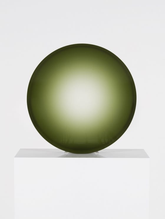 A Fred Eversley sculpture in the form of a green concave lens.
