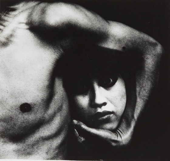 Image of male torso and arm holding a woman's head