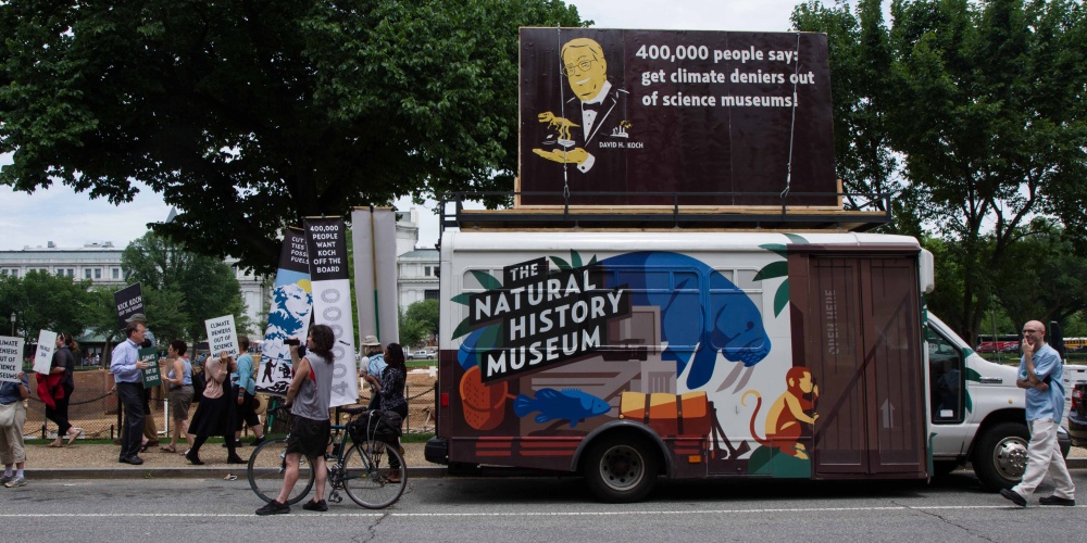 Photograph of a fifteen-passenger bus, on site for a petition delivery at the Smithsonian’s National Museum of Natural History