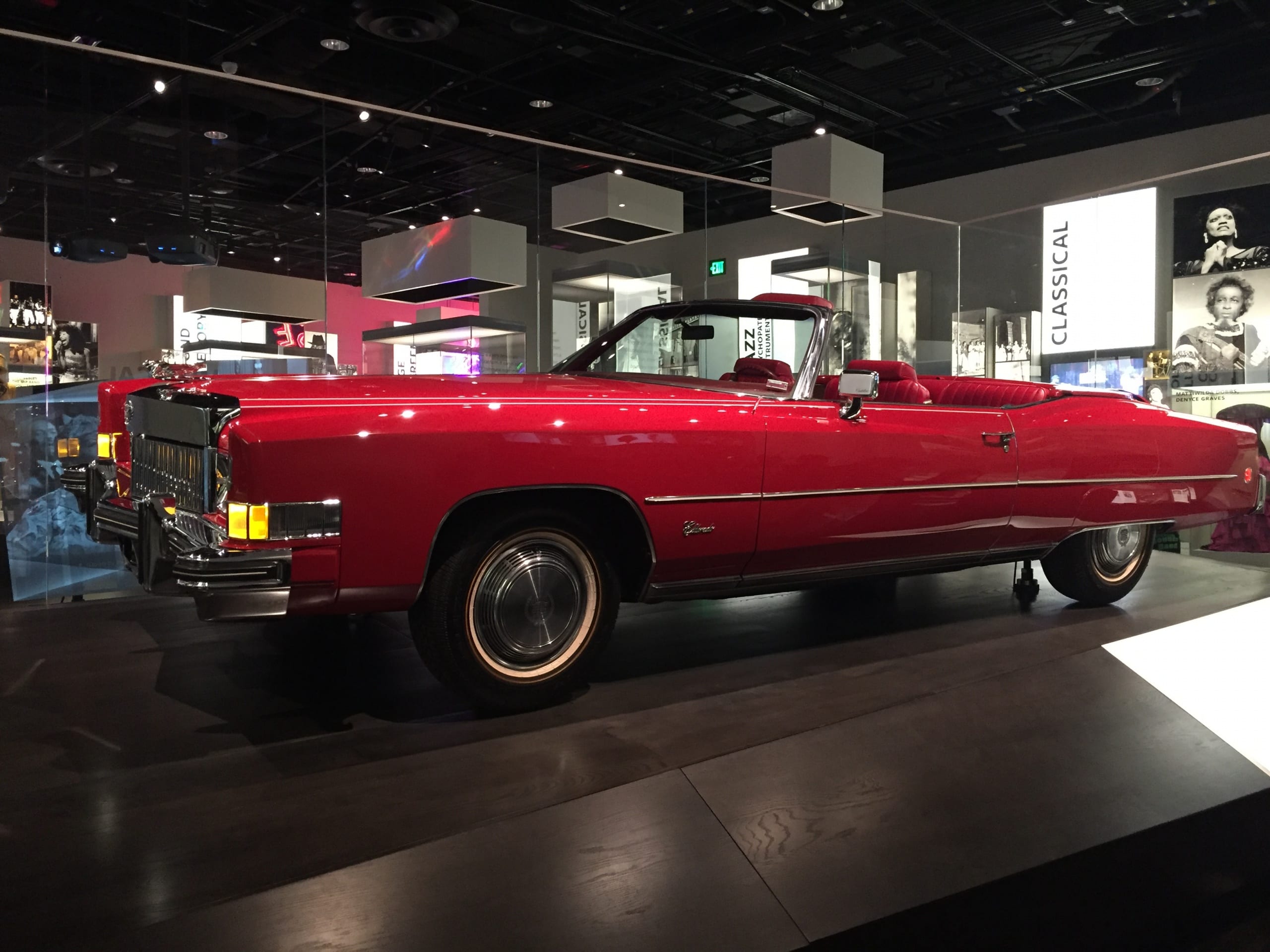 large shiny red Cadillac on a platform
