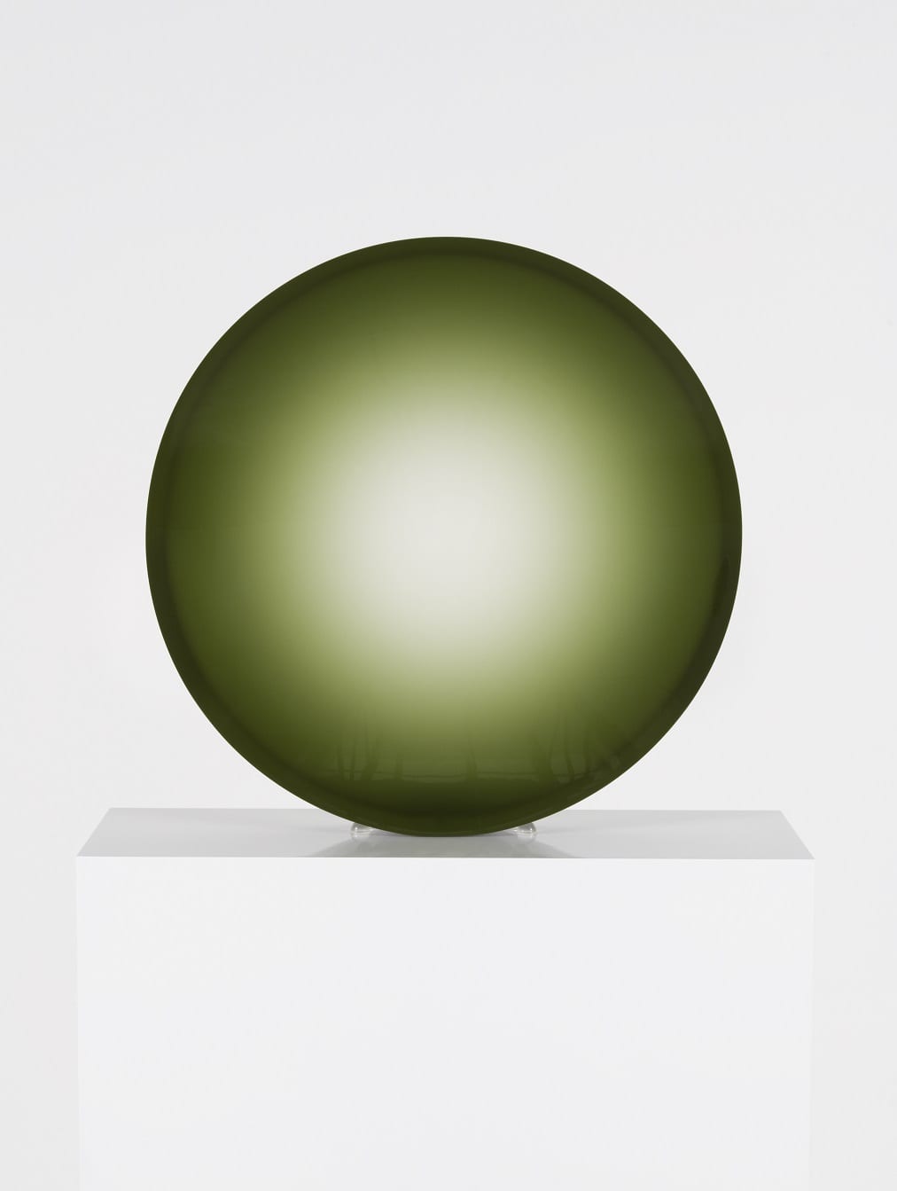 A Fred Eversley sculpture in the form of a green concave lens.